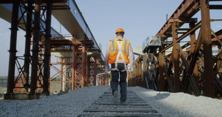 Unrecognizable builder walking on construction site